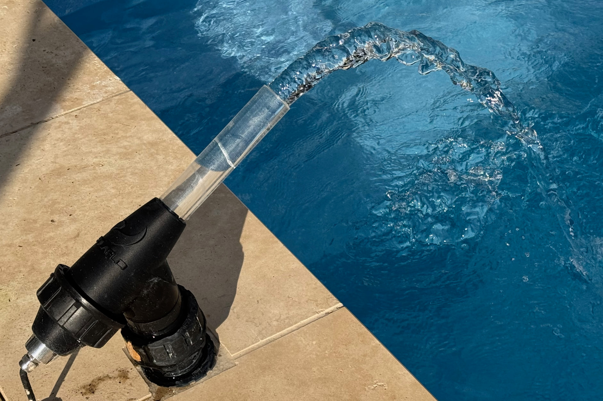 Close up of a laminar jet nozzle mounted flush in the pool deck