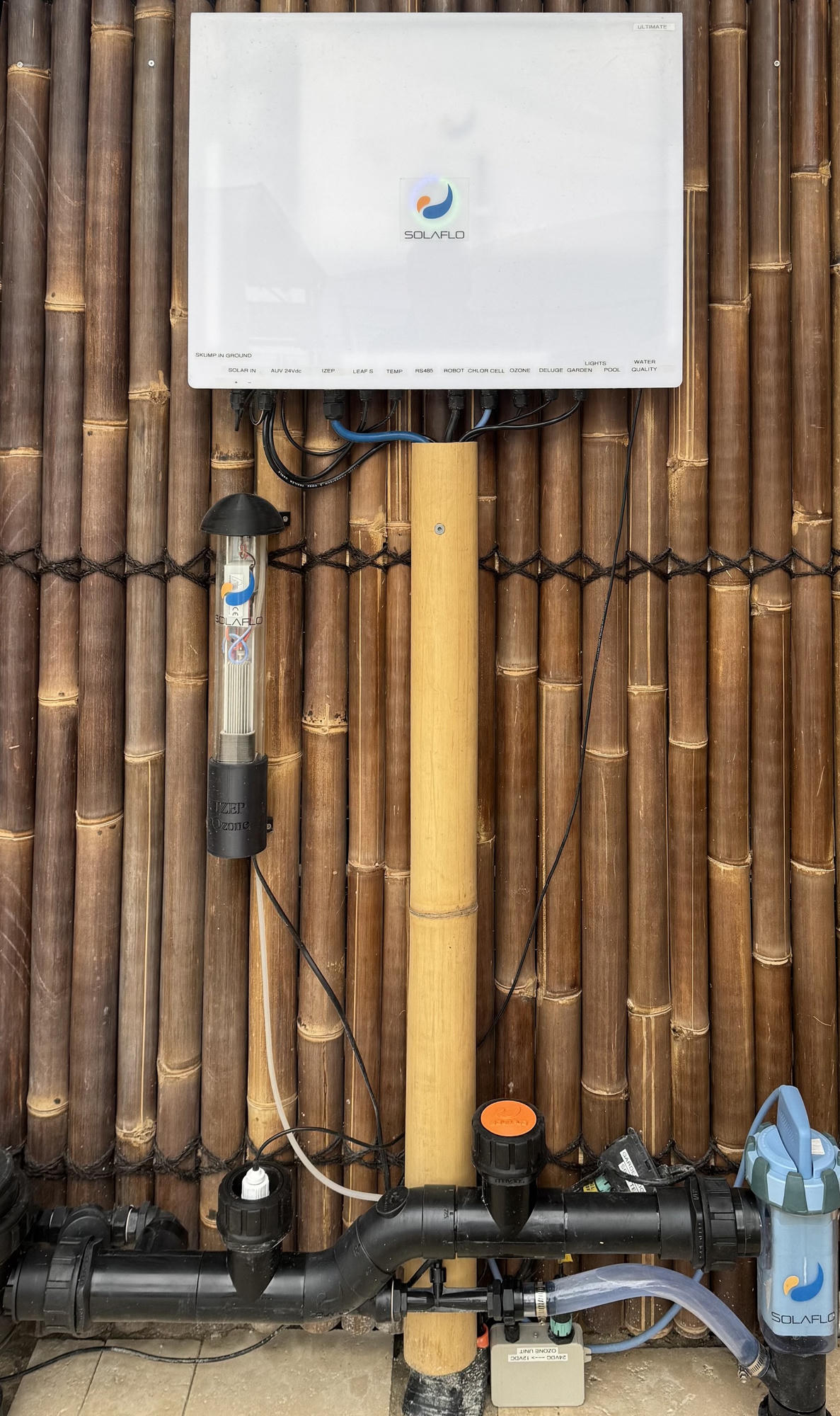 The SOLAFLO Ultimate controller with ozone and chlorination equipment mounted on a bamboo wall