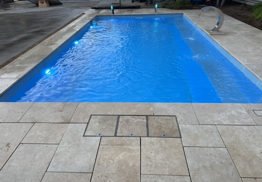 Pool with SOLAFLO SKUMP deck hatches installed at the waterline