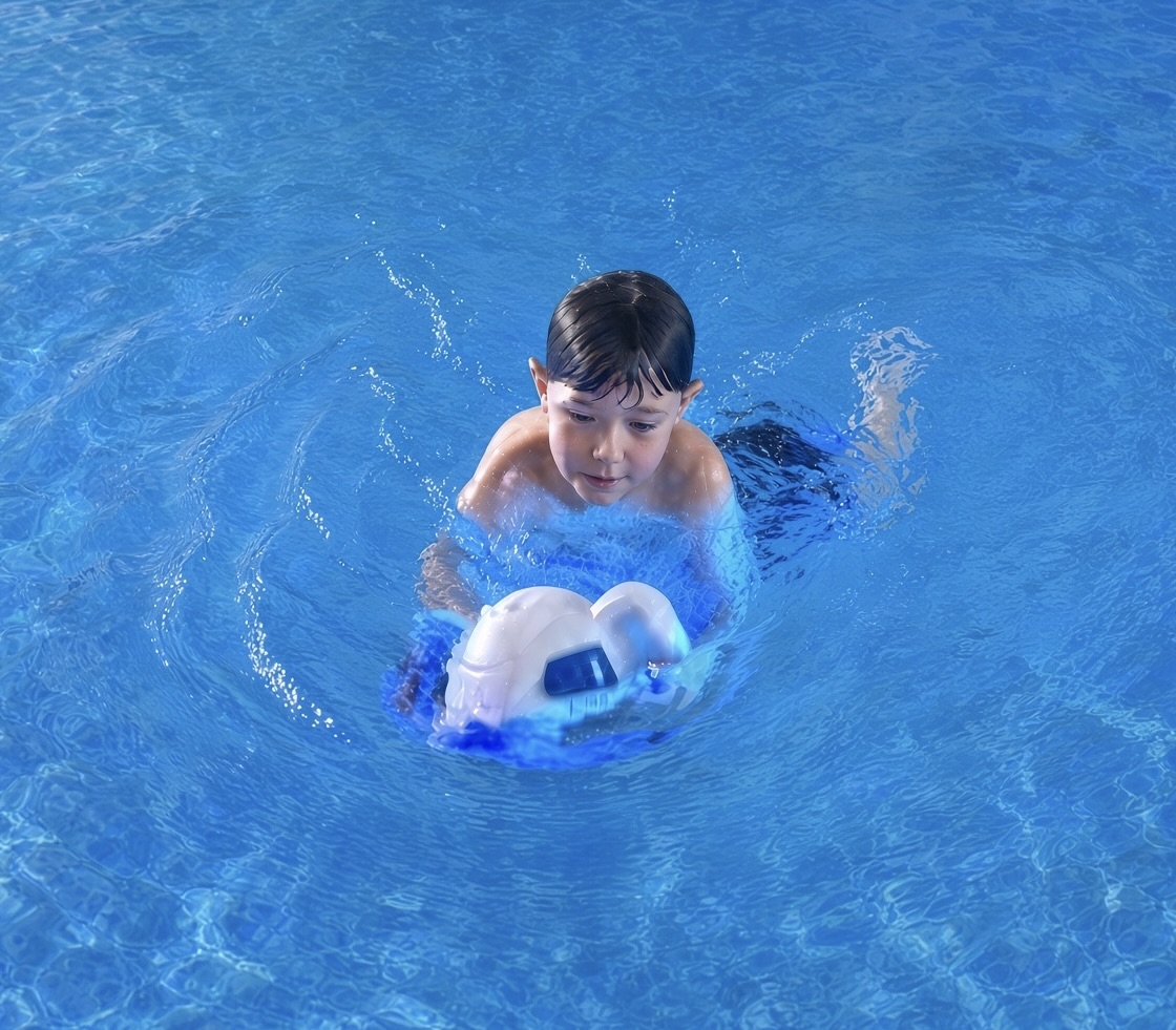 A child swimming with the SOLAFLO pump in a pool